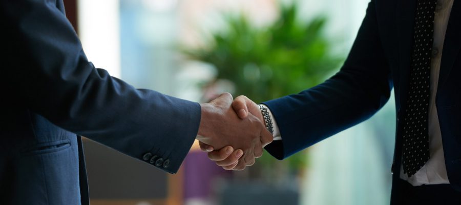 Business people shaking hands to confirm deal